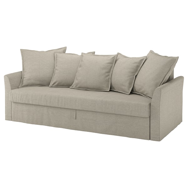 A beige HOLMSUND sofa with six cushions, designed for easy conversion into a bed, featuring a storage space and a modern, inviting design.