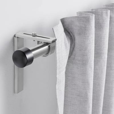 HUGAD silver curtain rod, adjustable, modern design, mounted on wall, with sleek metallic finish.