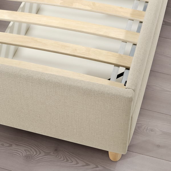 Modern upholstered bed with wooden slats, soft fabric, and sturdy construction.