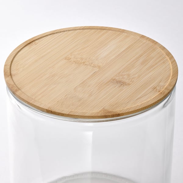 Clear glass jar with natural bamboo lid, stylish and functional, perfect for serving beverages.