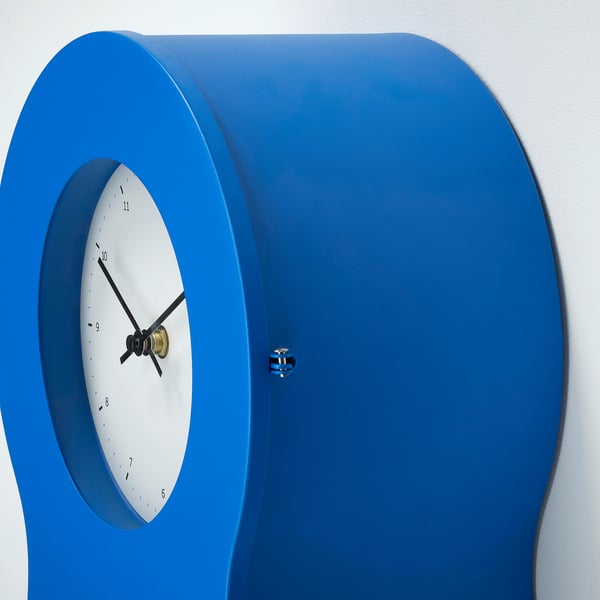 Vision-friendly, modern wall clock. Silent, blue design with a white face and gold hands. Stylish, accurate time display.