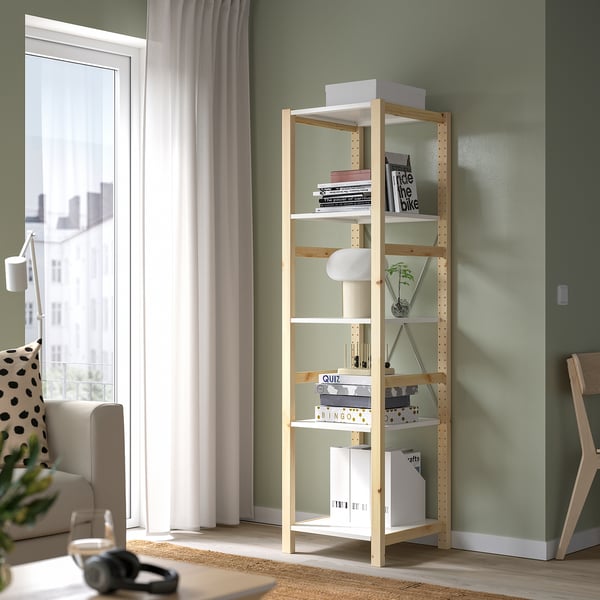 Natural pine IVAR bookshelf between sofa & window.