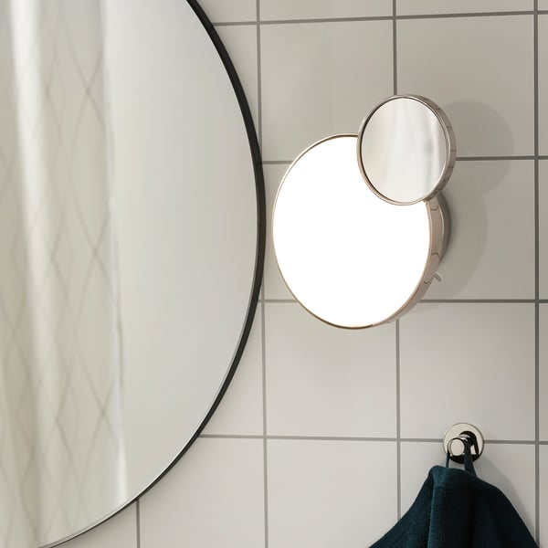 Modern bathroom wall lamp with detachable magnifying mirror and adjustable led light, designed for versatile lighting and grooming tasks.
