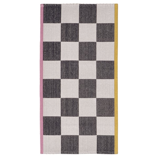 Lassrum rug, black & white chequered, pink and yellow borders, cotton and polypropylene, rectangular, retro style.