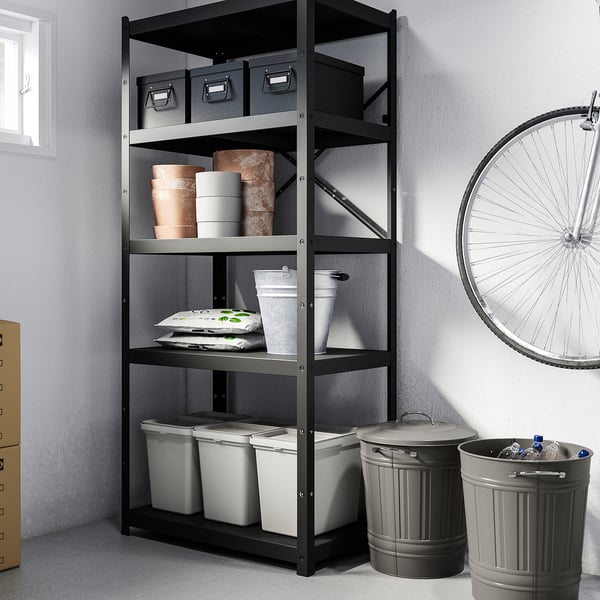 Metal storage rack with boxes, bins, cups, and bike wheel.