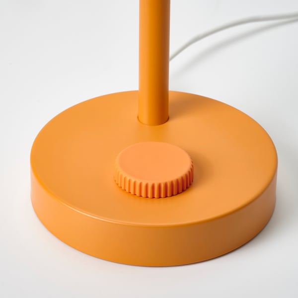 Orange floor lamp with round base, adjustable height, and built-in switch.