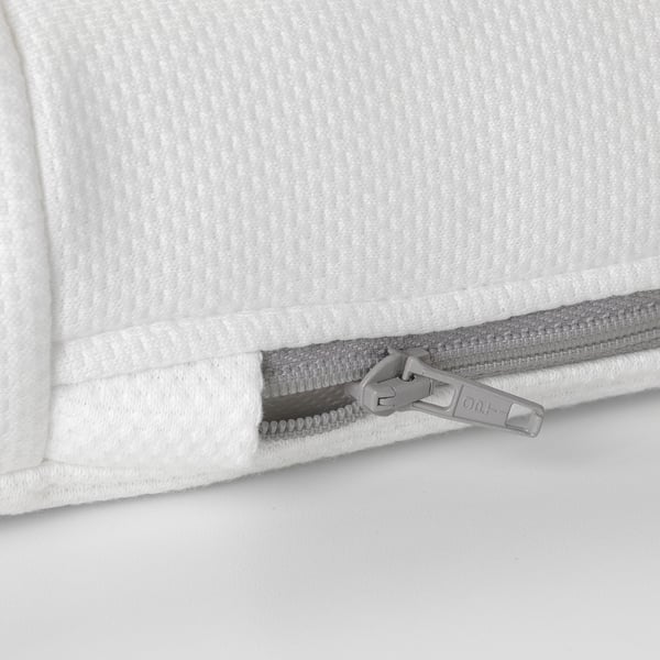 Close-up of a zip on a white mattress. High-quality materials, smooth zip pull visible.