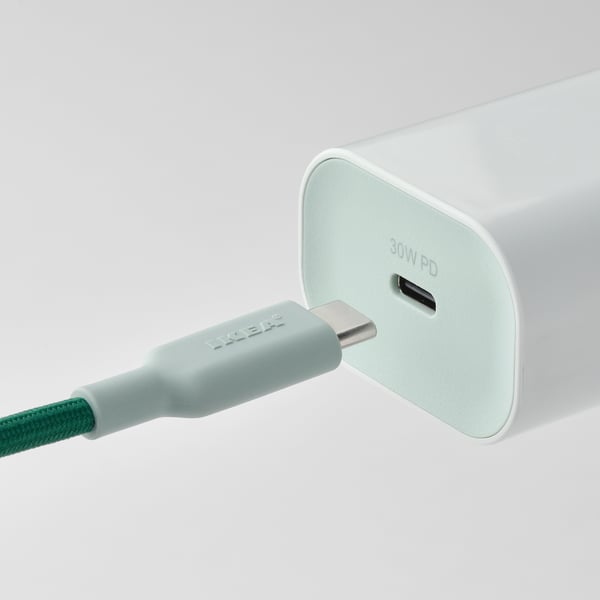 A green usb-c cable connected to a white charger, displaying 30w pd.