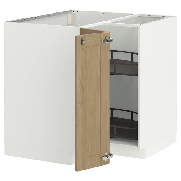 An open white kitchen cabinet with a wooden door. Inside, there are adjustable shelves for storage.