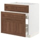 A METOD kitchen cabinet with walnut finish and wooden panels, featuring a white exterior and a drawer with a smooth close mechanism.