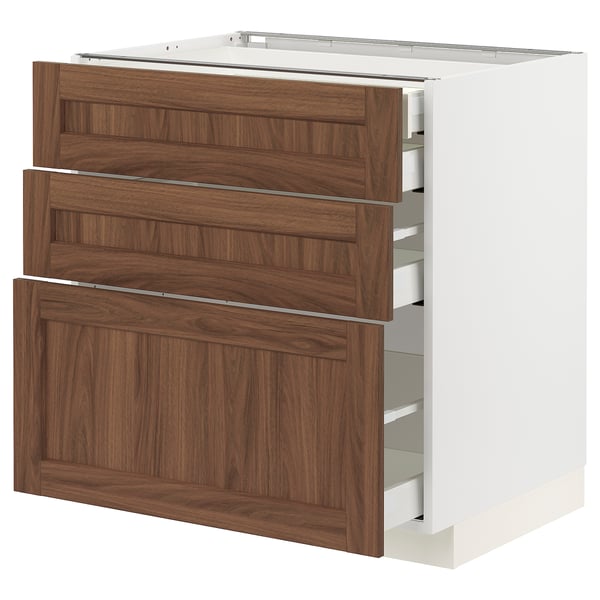 A white METOD kitchen cabinet with walnut grain drawers in a modern design.
