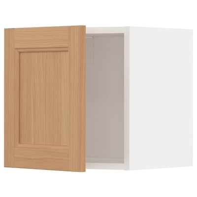 An ikea METOD kitchen cabinet with a natural oak wood door and white interior.