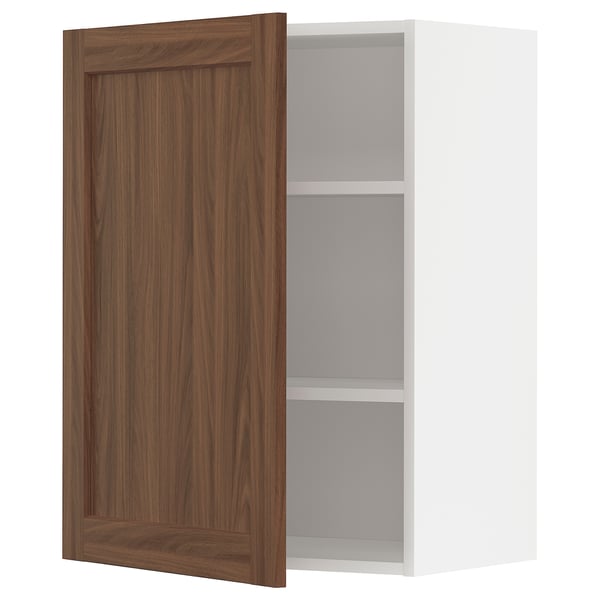 Walnut-colored cabinet door open, revealing a white shelf inside.