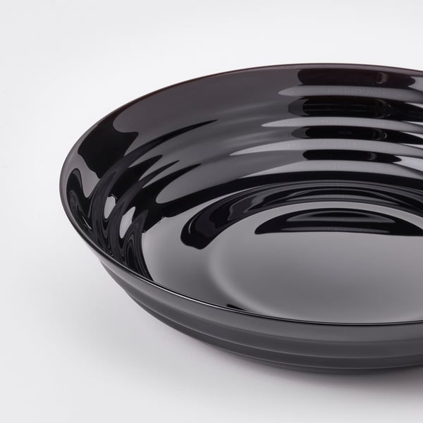 Black glossy glass bowl with smooth, rounded edges and reflective surface.