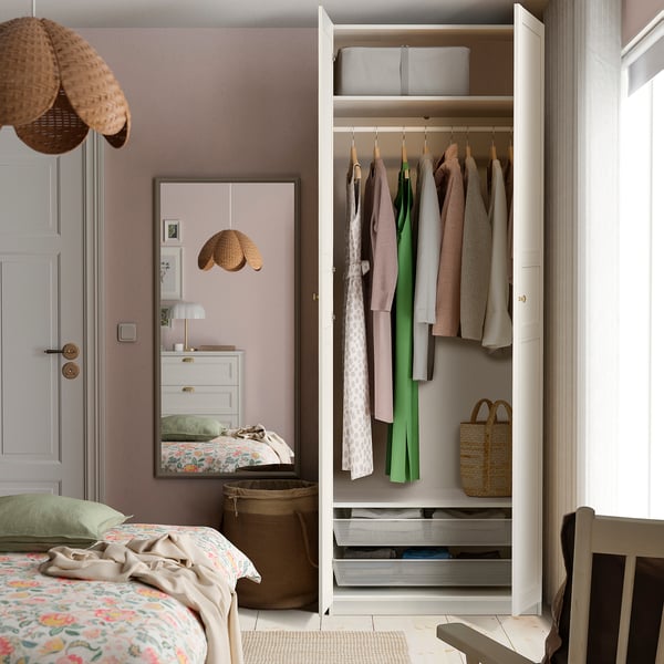 White wardrobe with hanging clothes, storage baskets, and shelves. Integrated lighting option. Soft-closing hinges visible.