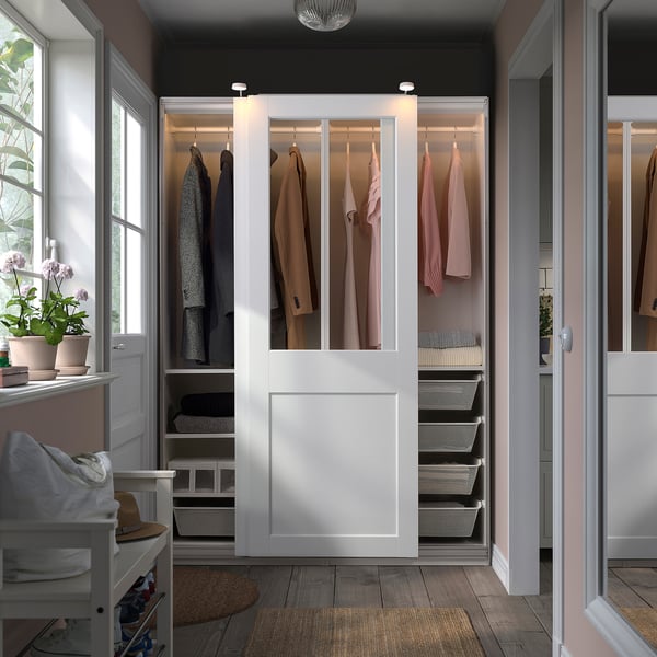 PAX wardrobe with glass doors, housing organised clothes, hats, and efficient storage.
