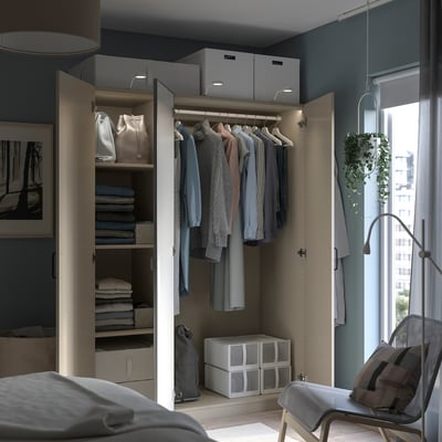Open wardrobe with clothes, shelves, and storage boxes. The frame is beige, with grey and beige items inside.