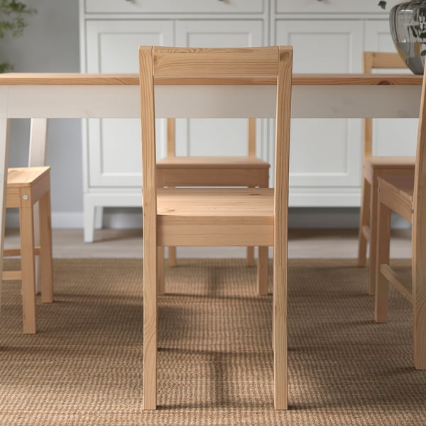 Wooden chair with angled backrest; part of matching dining set.