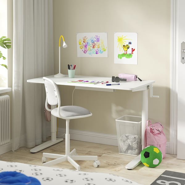 Childs study area with white RELATERA desk, chair, and colourful art.