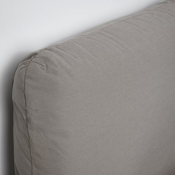 Upholstered bed with sloped headboard, showcasing quality fabric and design.
