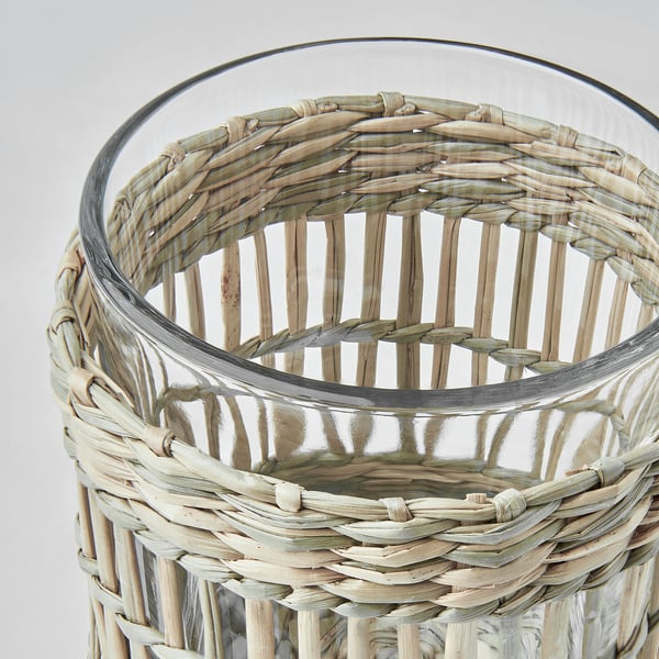 Handwoven sedge candleholder with clear glass lining, showcasing intricate natural texture and craftsmanship.