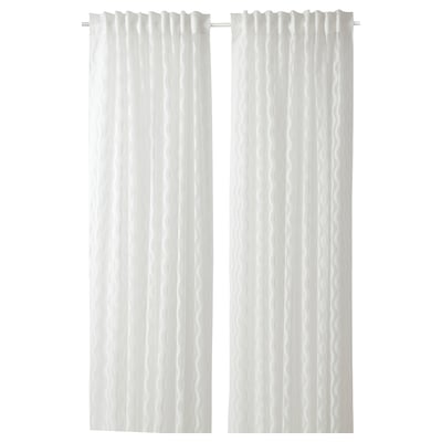 Two sheer white curtains hang side by side with a subtle wave pattern. They are made of 100% recycled polyester.
