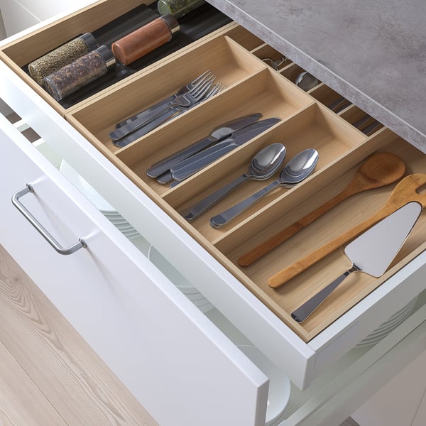 Organised kitchen drawer with compartments for cutlery and utensils.