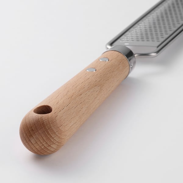 Stainless steel grater with wooden handle and hanging hole. Or sturdy stainless steel grater with wooden handle and hanging hook.