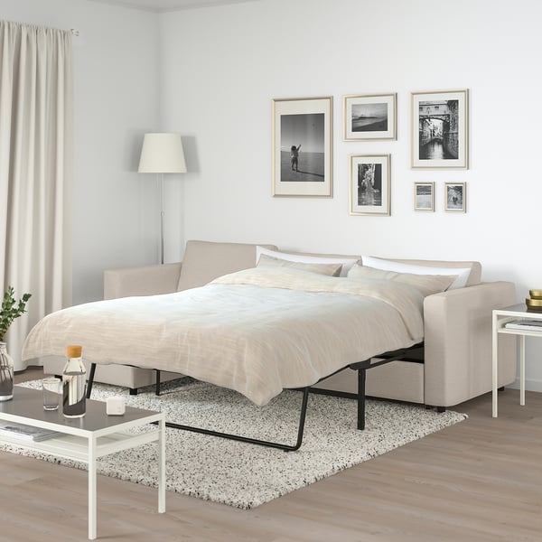 VIMLE beige sofa-bed with pillows, photos, lamp & table.