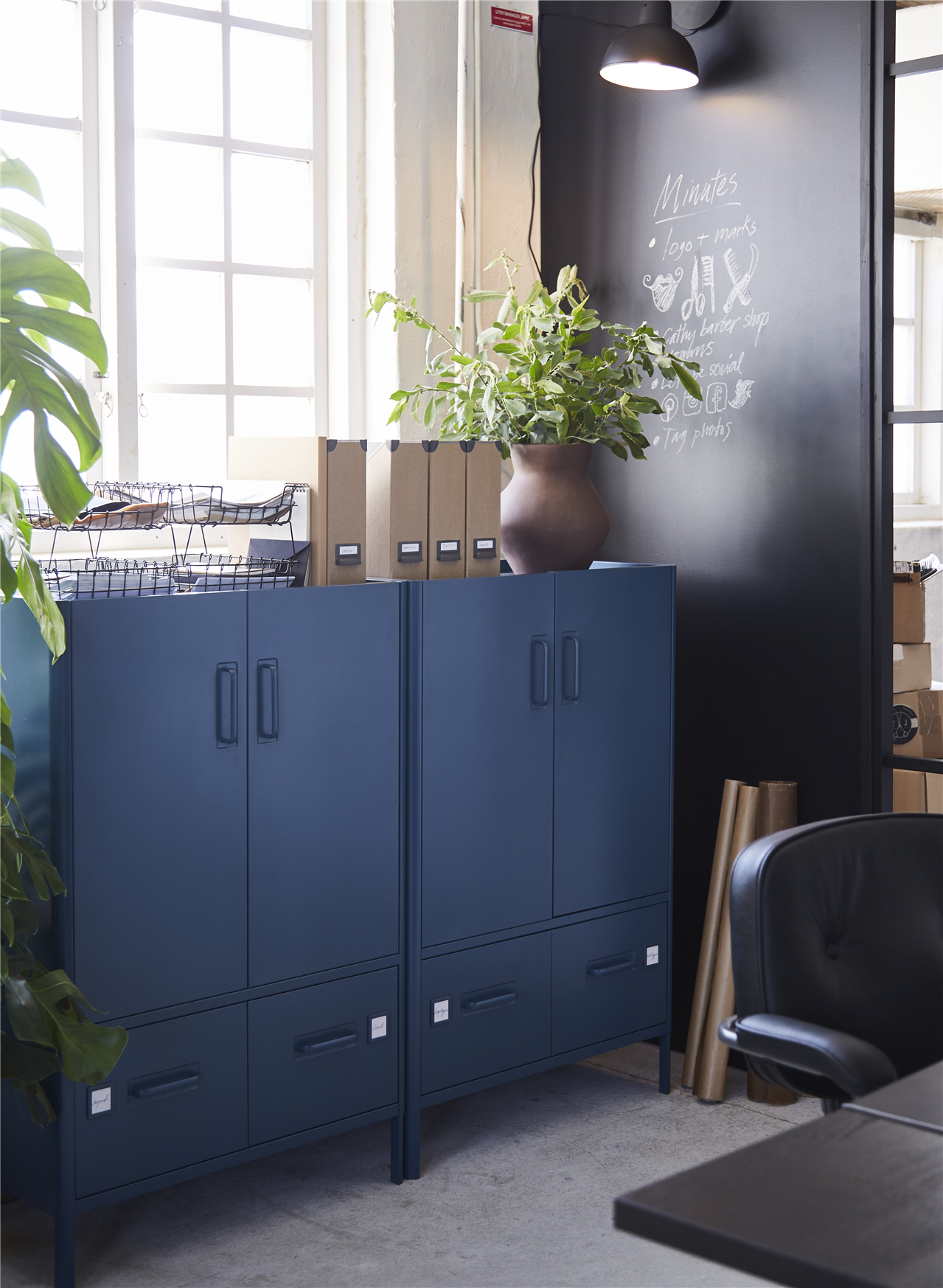 IDÅSEN dark blue cabinets with two drawers below on each unit, with potted plants and various items on top.