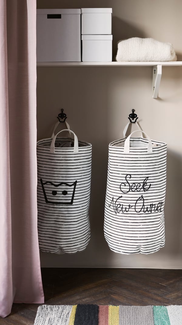A white/black KLUNKA laundry bag in the laundry room