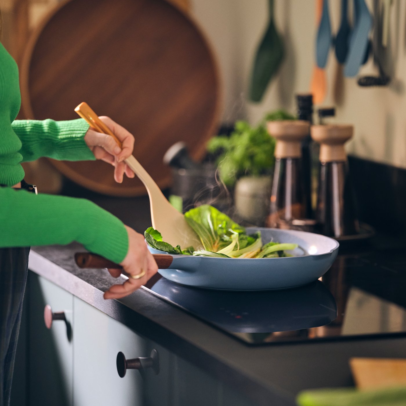 A high-gloss dark grey-green KALLARP drawer front in the kitchen