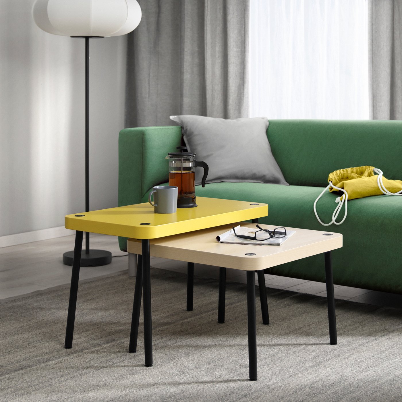 An yellow/birch effect SONHULT nest of tables in the living room