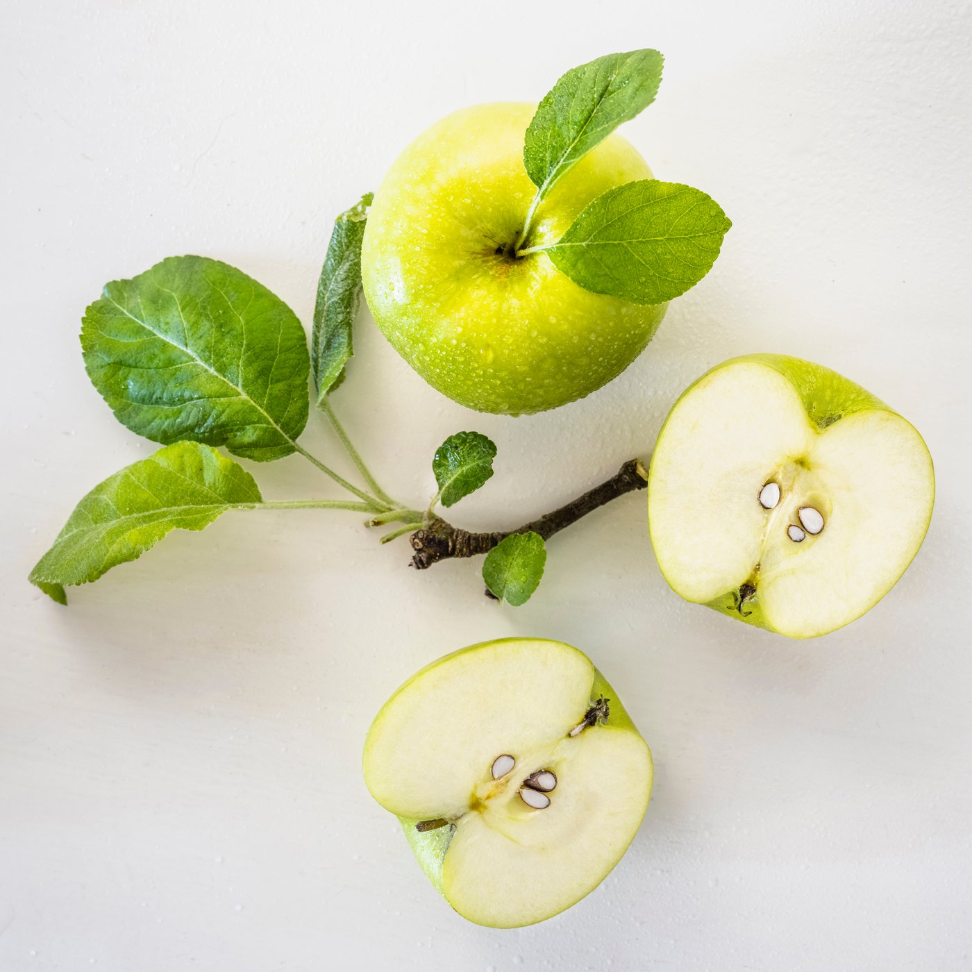 An Apple light green LOTSFÅGEL scented candle in glass