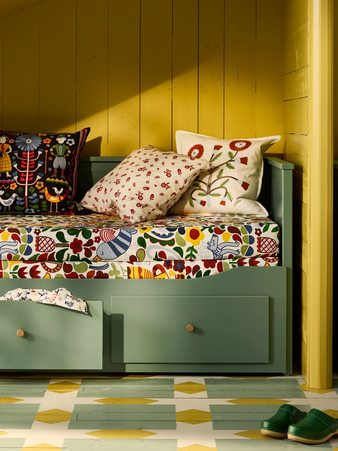 A grey-green HEMNES day-bed frame with 3 drawers