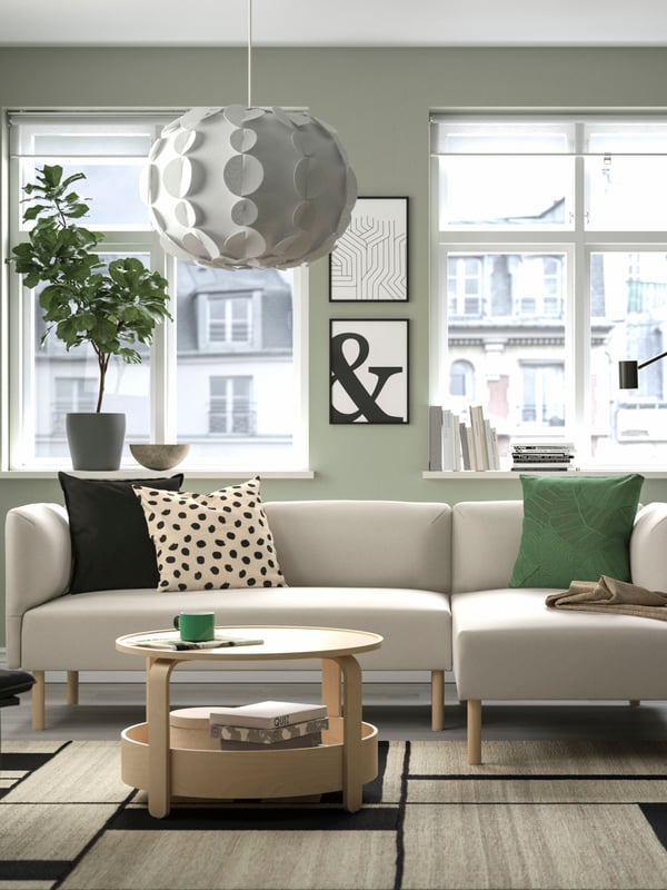 Beige LILLEHEM sofa with lounge seat in the living room on top of a RASTPLATS rug with a BORGEBY coffee table. 