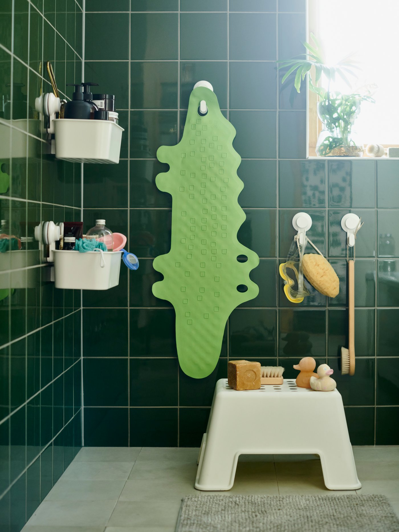 TISKEN wall hooks with towel rack, storage basket and towel hooks shown on a yellow tiled wall with yellow towels on them.