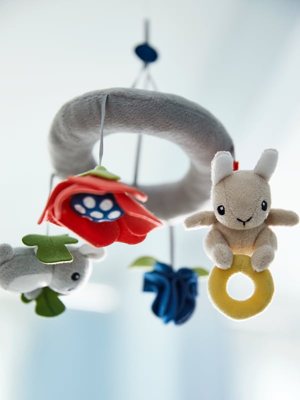 A multicolour GULLIGAST mobile with different animals, flowers and shapes.