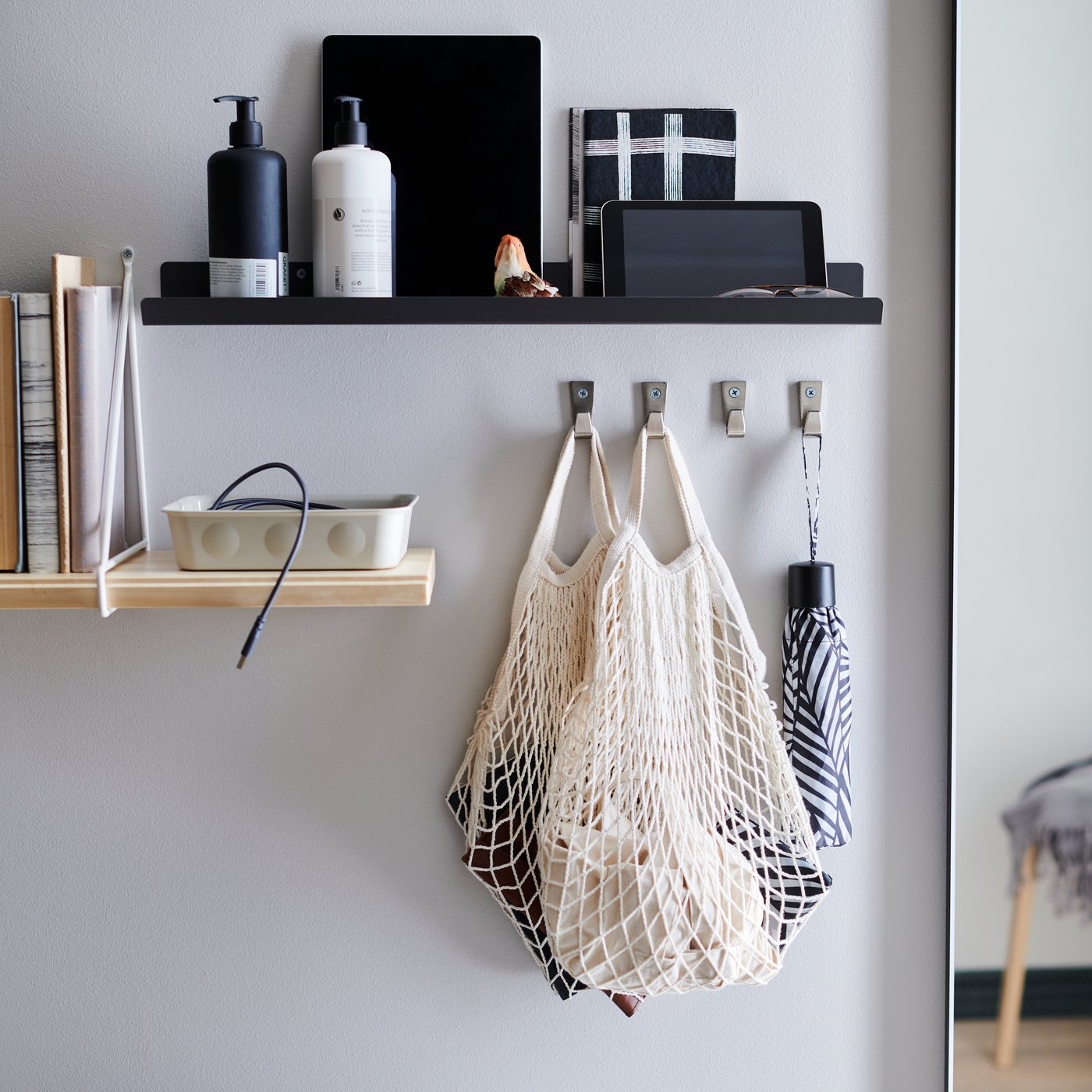 Standing on an old, worn chest of drawers are a set of RAGGISAR textile baskets, filled with trinkets and clutter.