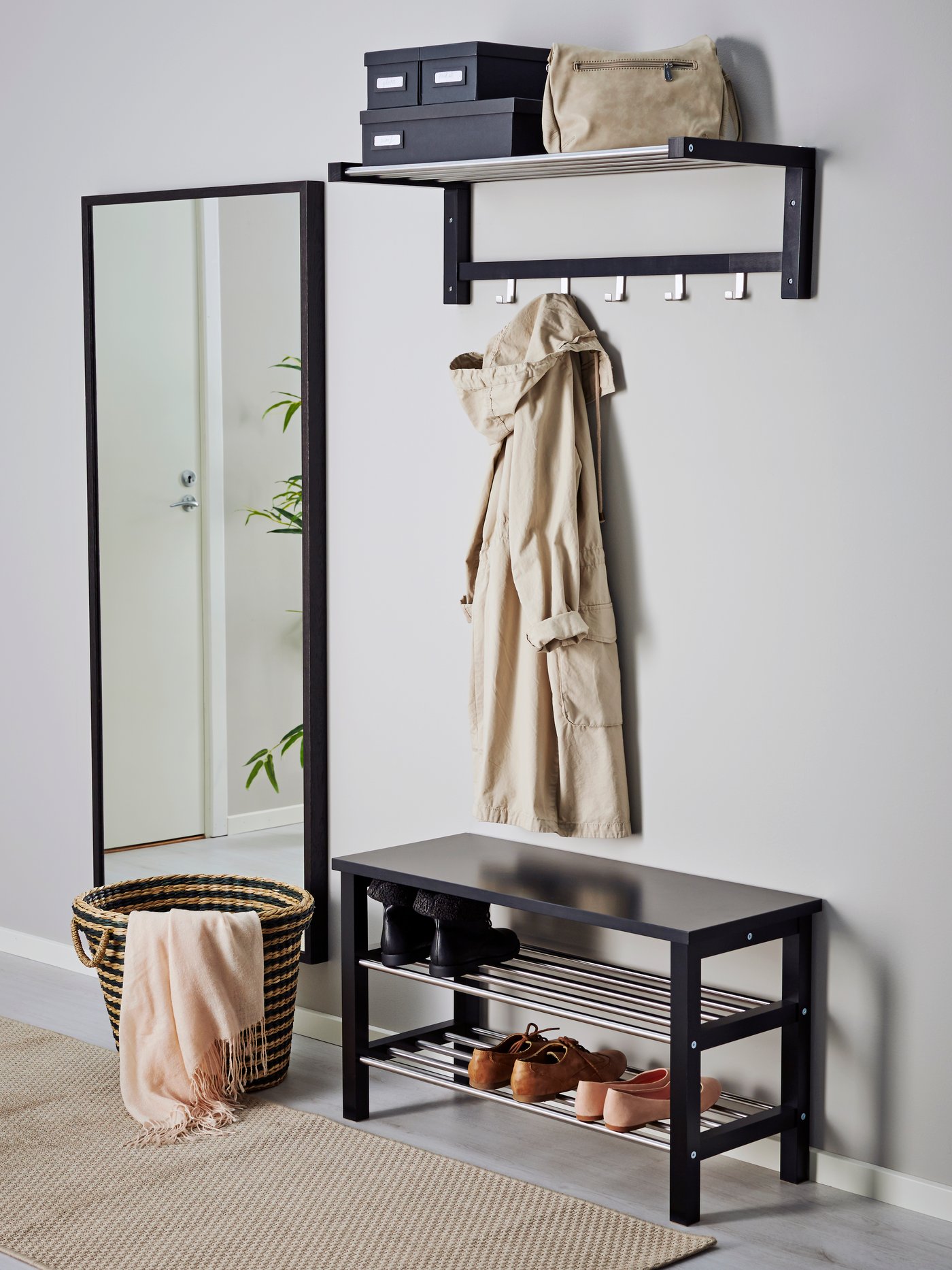 A black TJUSIG bench with shoe storage