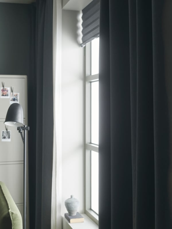 A black SKURUP floor/reading lamp in the living room