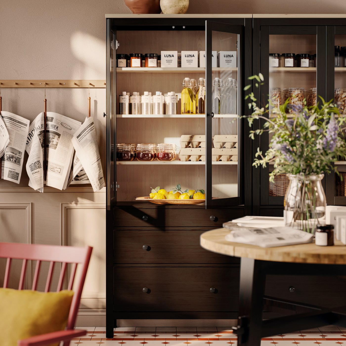 Jars and bottles are on display in a black-brown HEMNES glass-door cabinet with three drawers in a classic-styled reception.