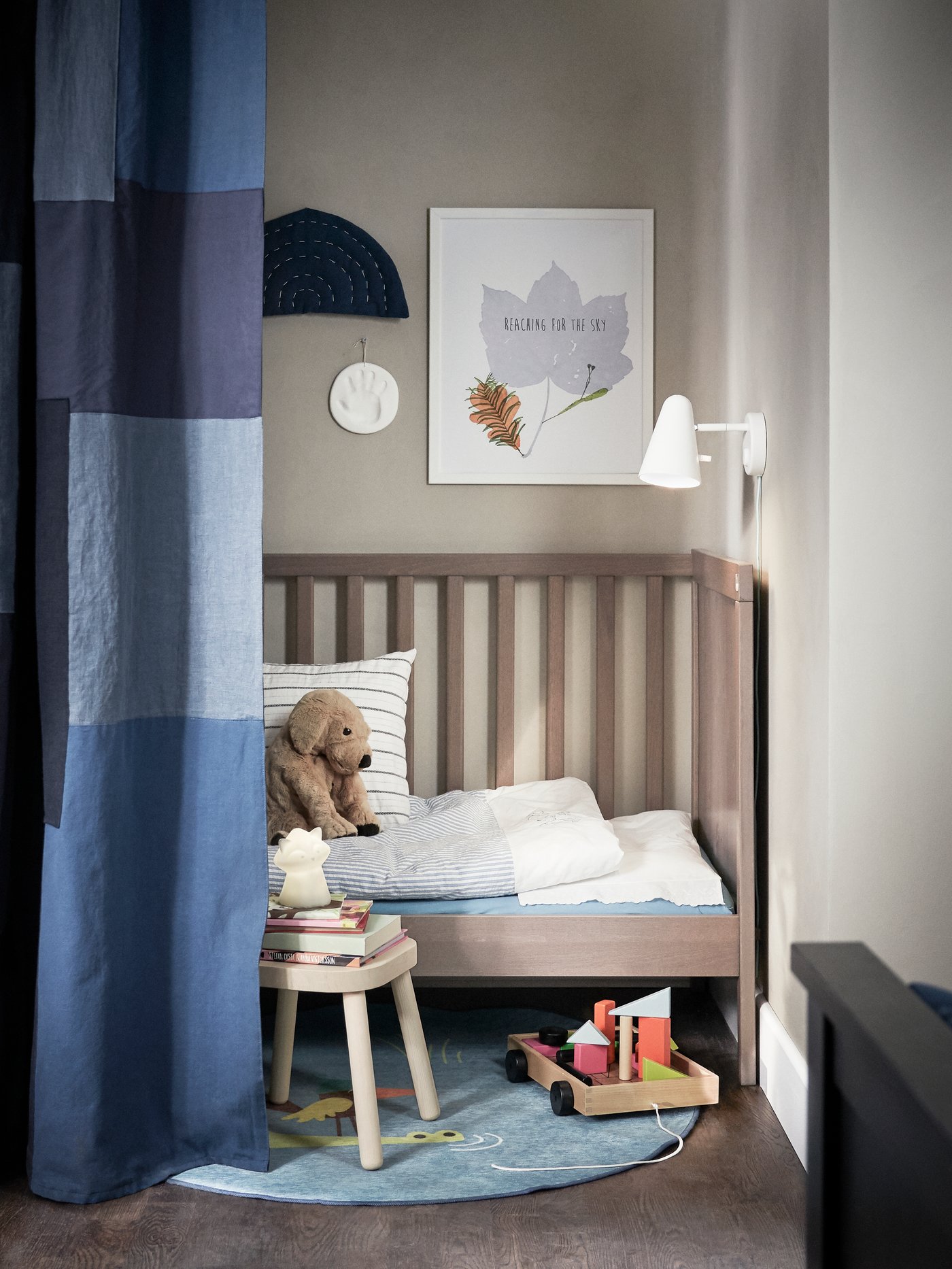 A grey-brown SUNDVIK cot in the childrens room