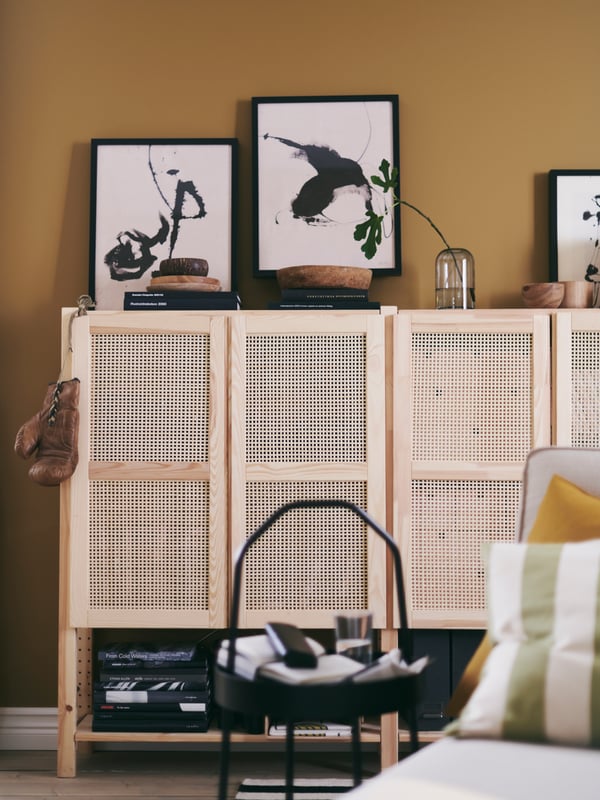 IVAR shelving units with bamboo doors create both storage and display space in a warm, casual living area.