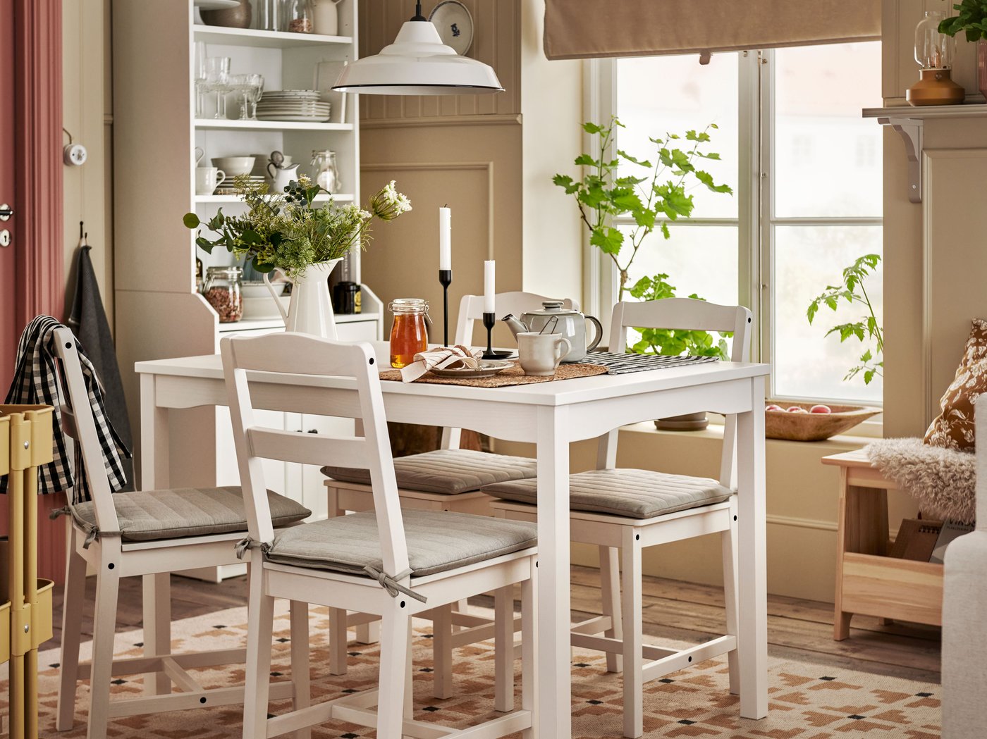 A white HAUGA table and four white HAUGA chairs stand in a dining area styled as a modern farmhouse dining room.