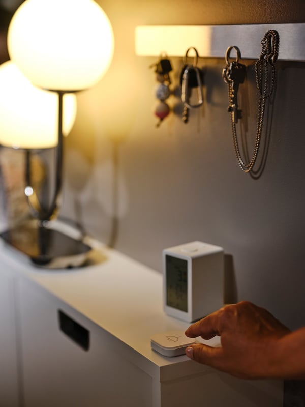 a person using a remote control to change the light