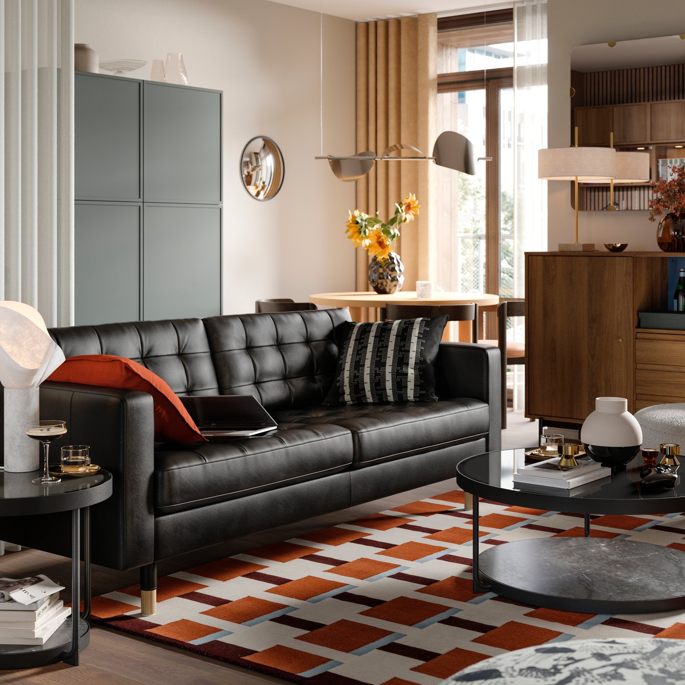 A leather and coated fabric 3-seat sofa stands in a living room near some BESTÅ storage and a RÅDMANSJÖ cabinet.