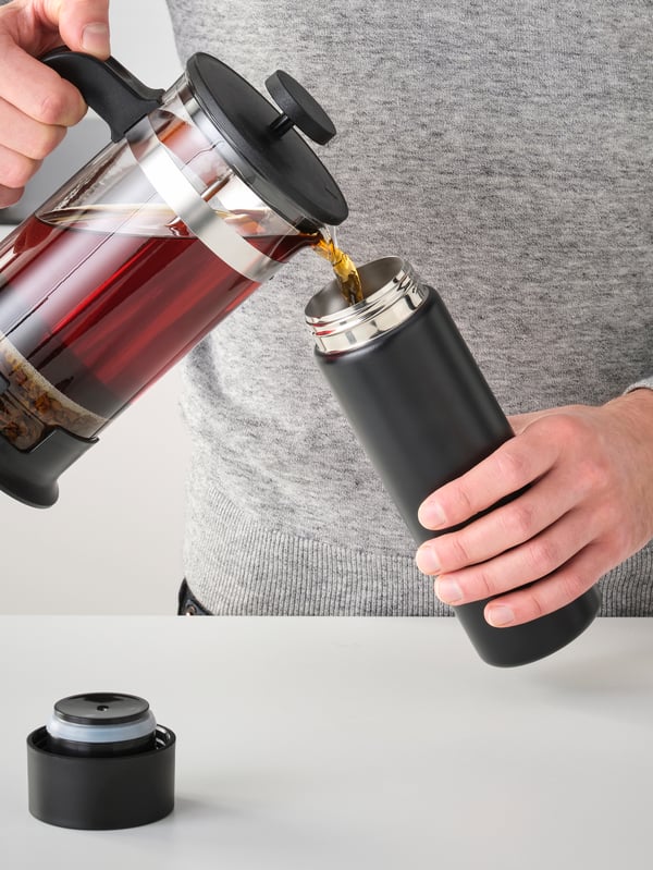 A black UNDERSÖKA insulated travel mug