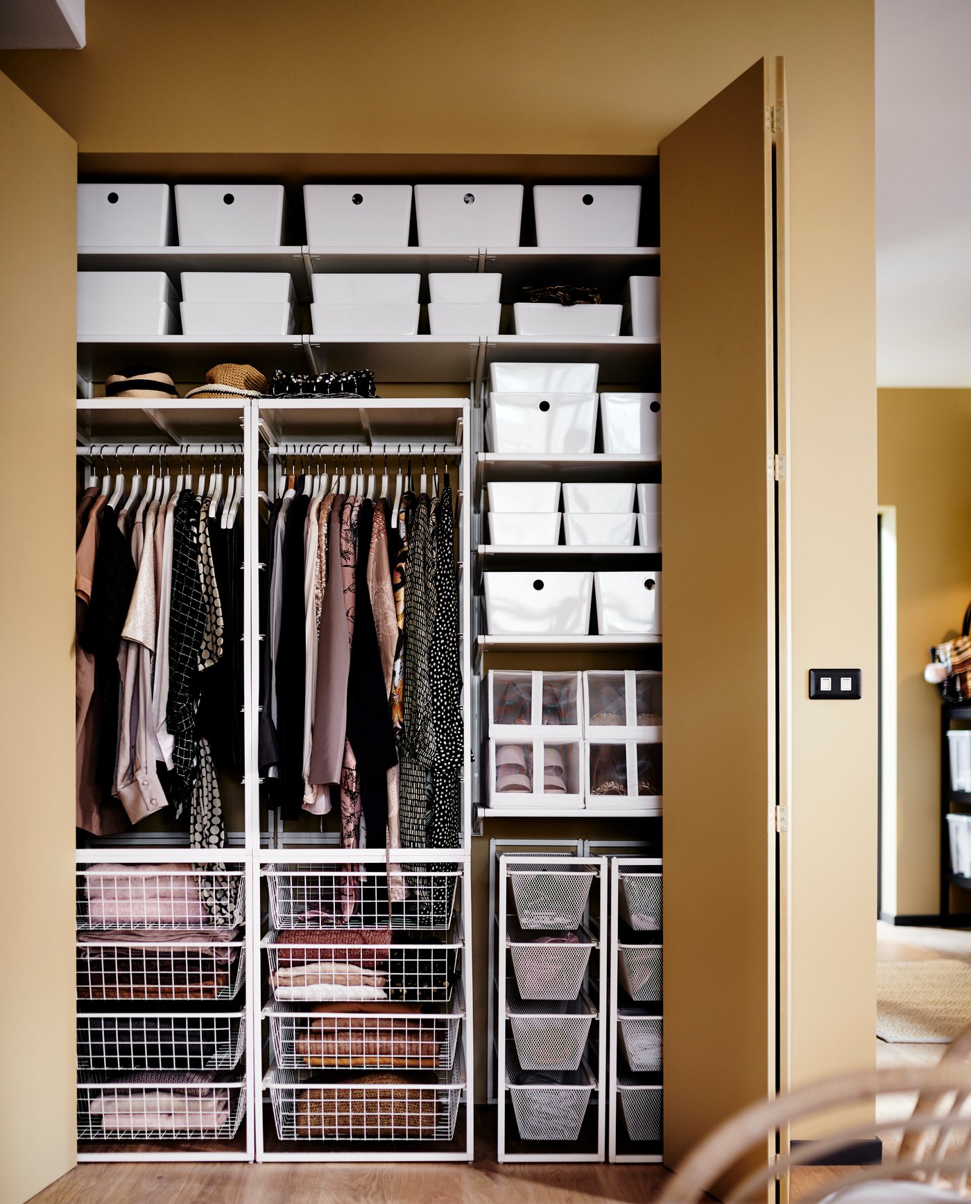 A white KUGGIS storage box in the bedroom