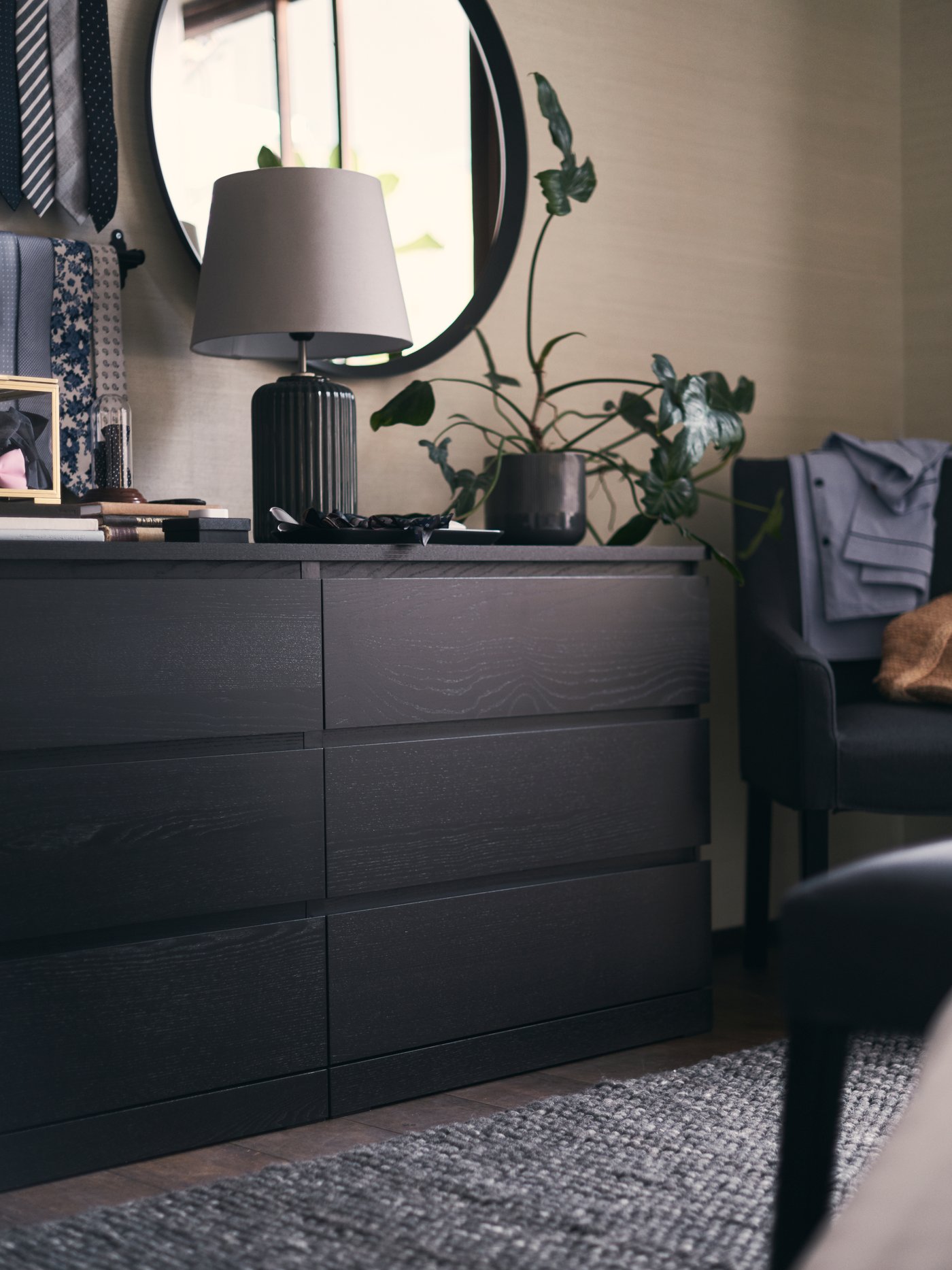A dark grey LANGESUND mirror in the bedroom